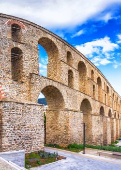 Cityscape with medieval aqueduct Kamares in the Kavala city, Macedonia, Greece.